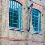 Green aluminium heritage windows on building