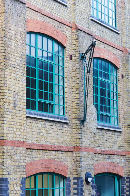 Green aluminium heritage windows on building
